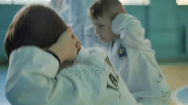 Funny male kids training a taekwondo in the gym in 4K — Stock Video