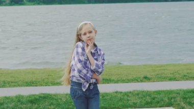 Göz alıcı ve şık sarışın kamera sahilde poz. Yavaş yavaş