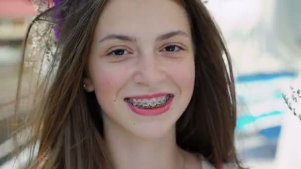 Portrait of happy female teen with braces on teeth smiling at camera. 4K — Stock Video