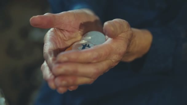 Wrinkled old female hands holding many golden and silver bitcoins — Stock Video