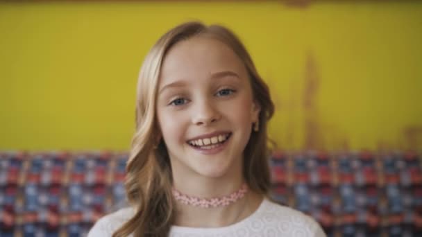 Portrait of happy young girl smiling at camera. 4K — Stock Video