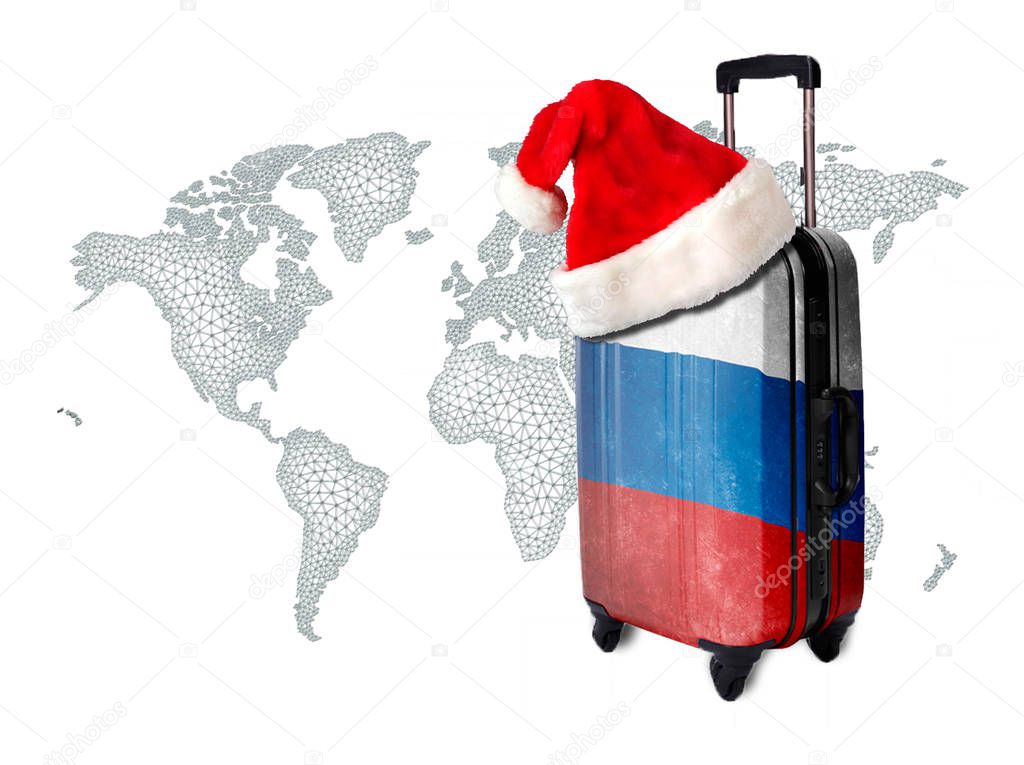 Suitcase with the texture of the flag of Russia on wheels with a cap of Santa Claus against the backdrop of the world.