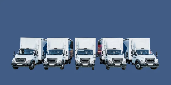 Five white truckers in the parking lot are waiting for their next delivery of goods. The concept of a transport company for the delivery of goods around the world. Isolate
