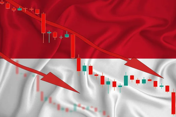 Indonesia flag, the fall of the currency against the background of the flag and stock price fluctuations. Crisis concept with falling stock prices of companies.