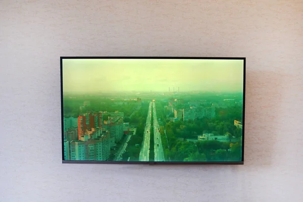 Large TV on a light wall in a room in a modern style. Close-up. Horizontal