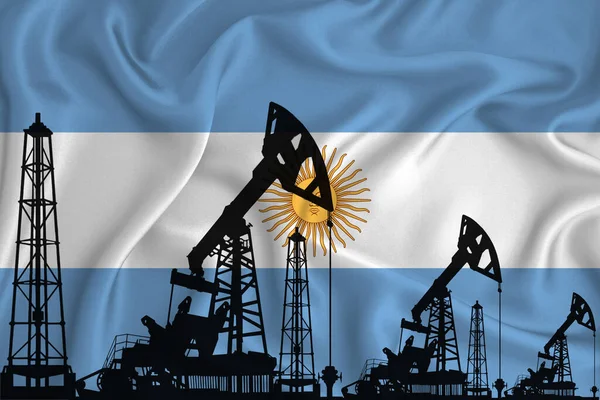 Silhouette of drilling rigs and oil derricks on the background of the flag of Argentina. Oil and gas industry. The concept of oil fields and oil companies.