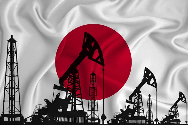 Silhouette of drilling rigs and oil derricks on the background of the flag of Japan. Oil and gas industry. The concept of oil fields and oil companies.