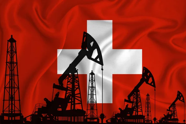 Silhouette of drilling rigs and oil derricks on the background of the flag of Switzerland. Oil and gas industry. The concept of oil fields and oil companies.