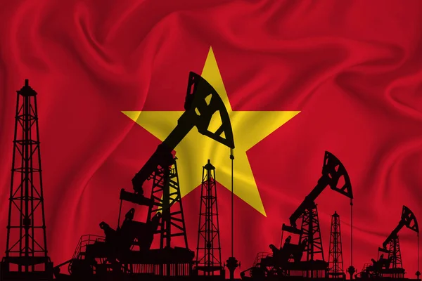 Silhouette of drilling rigs and oil derricks on the background of the flag of Vietnam. Oil and gas industry. The concept of oil fields and oil companies.