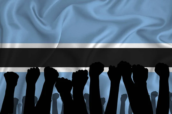 Silhouette of raised arms and clenched fists on the background of the flag of Botswana. The concept of power,  conflict. With place for your text. 3D rendering