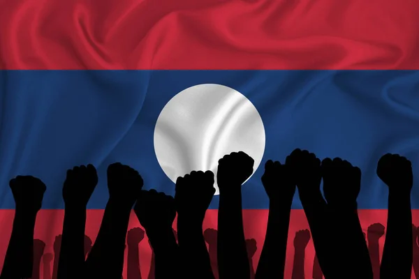 Silhouette of raised arms and clenched fists on the background of the flag of Laos. The concept of power,  conflict. With place for your text. 3D rendering