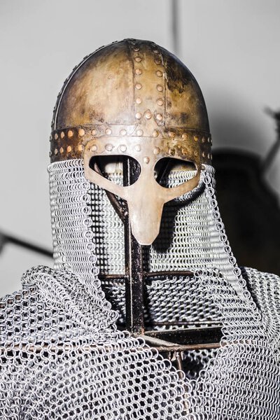 Chain mail and helmet on the exhibition on the iron structure