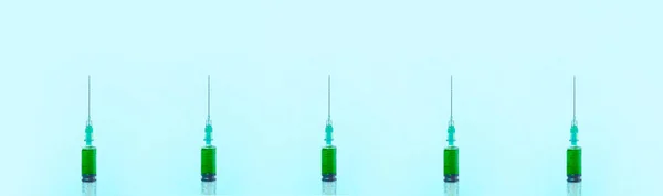 Green liquid in a syringes panoramic — Stock Photo, Image