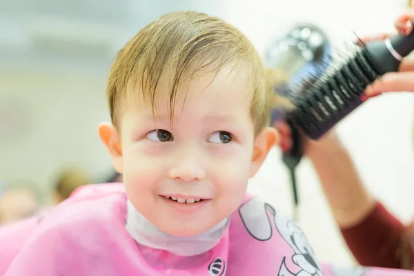 The boy is cut in the hairdresser's — Stock Photo, Image