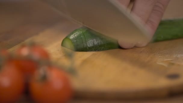 Man cutting cucumber longitudinally — Stock Video