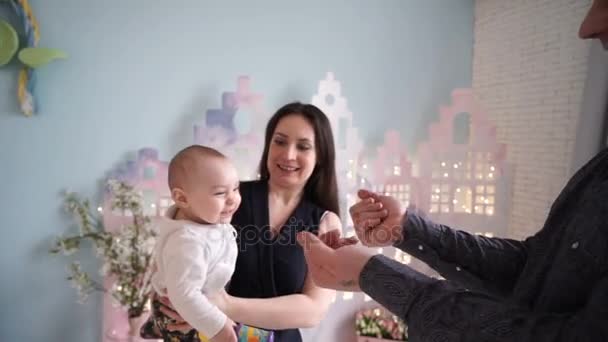 Madre, padre y su bebé recién nacido. Feliz mamá y papá besando y abrazando al bebé recién nacido . — Vídeos de Stock