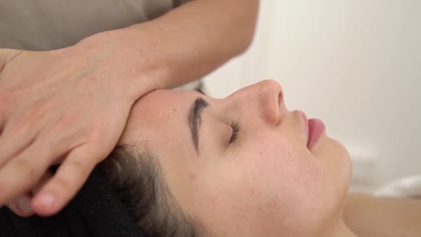 Spa kvinna ansiktsmassage. Ansiktsmassage i skönhetssalong. Kvinnliga njuter av avslappnande ansiktsmassage i kosmetologi spa centrum. Närbild — Stockvideo