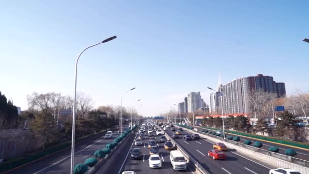 Beijing, China, January 2020. Traffic scene, long shot of highway filled with cars and buses at sunny day in winter — 비디오