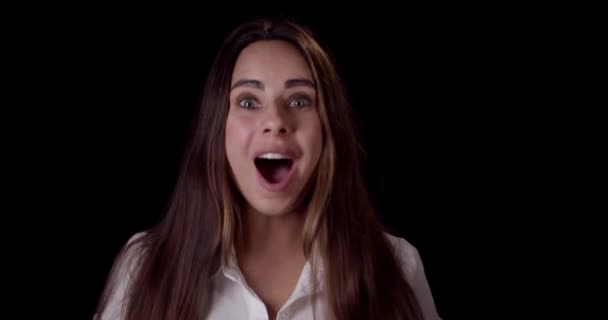 Young woman celebrating and enjoy victory win good news joy winning success on moving in confetti in studio. Portrait of happy caucasian excited teenage girl smiling laughing on black background, — Stock Video