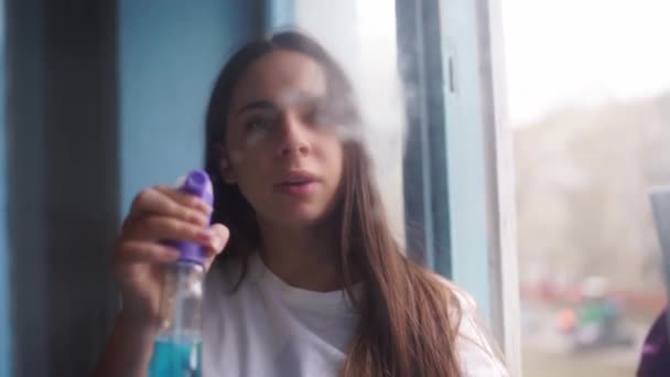 House cleaning. Young woman in pink gloves wash window with white rag and detergent. — Stock Video