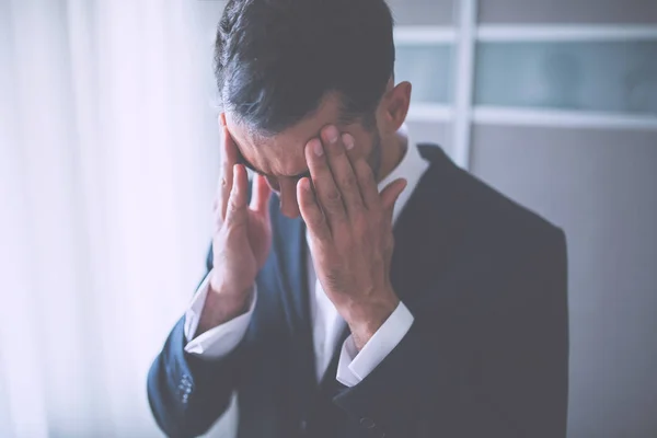Headache of business man. Thinking of problem on office background. Holding his head. — Stock Photo, Image