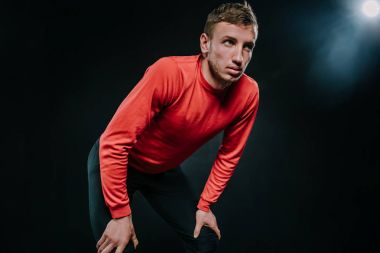 Dinlenme uzakta ciddi bir ifadeyle seyir spor, eğitim sırasında mola sırasında sahip onun nefes yakalamak için üzerine yaslanmış çekici genç Kafkas koşucu. Yaşam tarzı, spor, motivasyon.