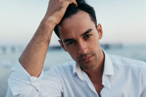 Close up portrait of handsome man wearing white shirt at the sea — Stock Photo, Image