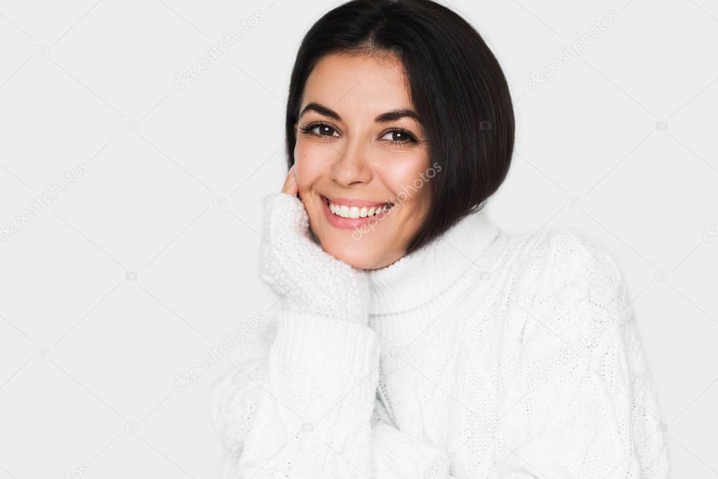 Beautiful young happy woman looking pensive and happy in white s