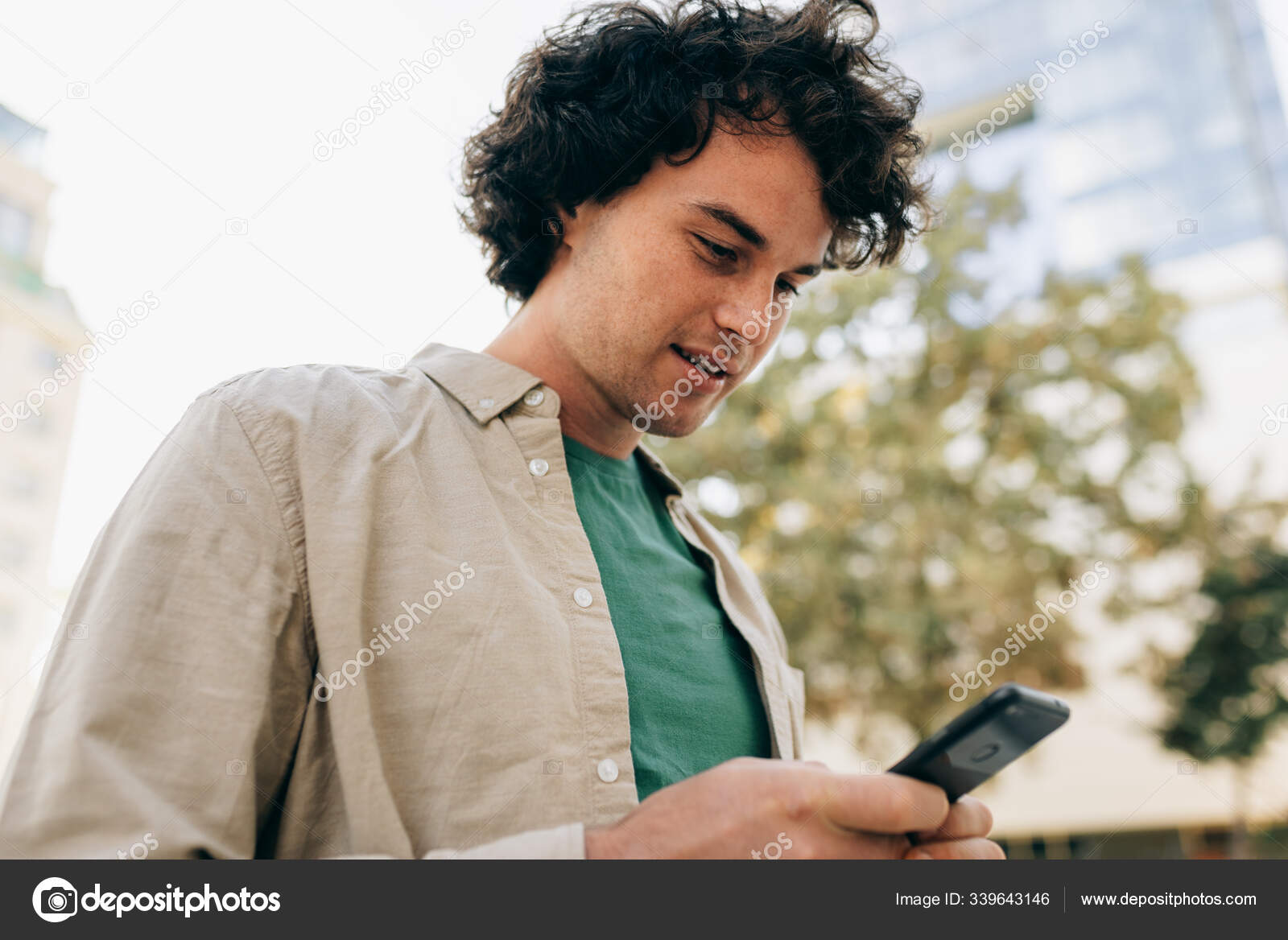 Кавказский Умный Молодой Человек Стоит На Улице, Печатает.