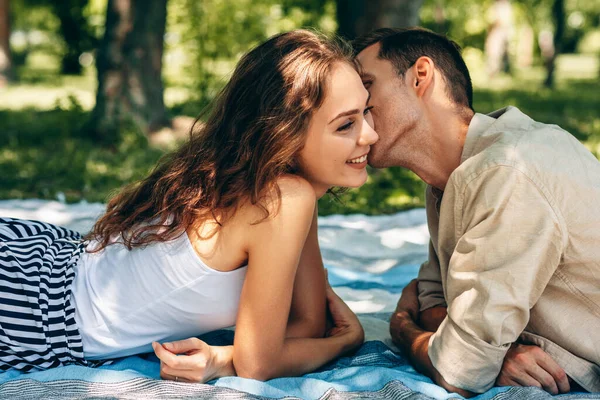 Adorable couple in love dating outdoors at the park on a sunny day. Happy couple in love embracing each other, looking with love having eyes full of happiness. Date day. Family time — Stockfoto