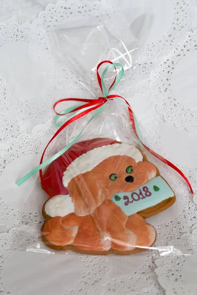 Christmas sweets in a festive package, colorful gingerbread, cookie in the form of a dog with New Years mood. Year of the dog. Dog symbol of the year 2018. Close-up. Colorful christmas Gingerbread.