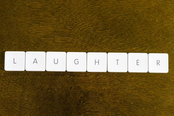 Laughter Cuvânt Scris Alfabet Tastatură Din Plastic Fundal Întunecat — Fotografie, imagine de stoc