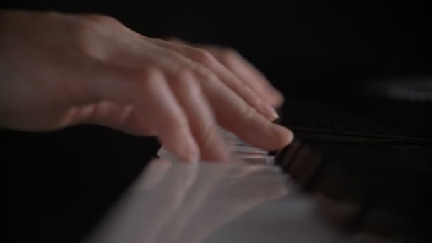 Shallow depth of field hands of woman playing piano keyboard press on black and white key — Stock Video