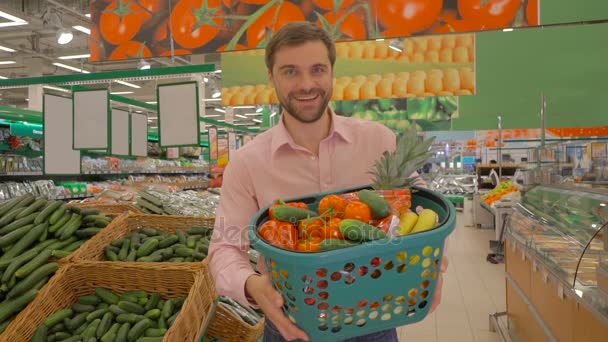 Радостный человек держит корзину свежих овощей — стоковое видео