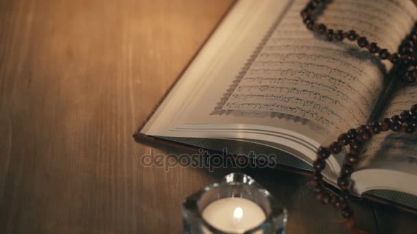 Heilige Koran met kralen over houten achtergrond — Stockvideo