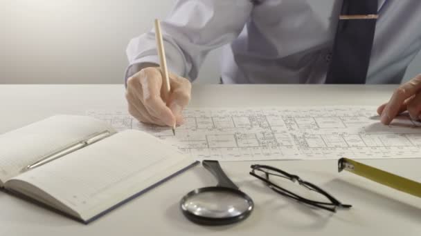 Architect or engineer using pencil working on blueprint, architectural concept — Stock Video