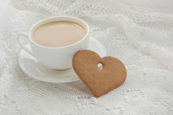 Cup of coffee with cookies as heart on lace. Windowsill. — Stock Photo, Image