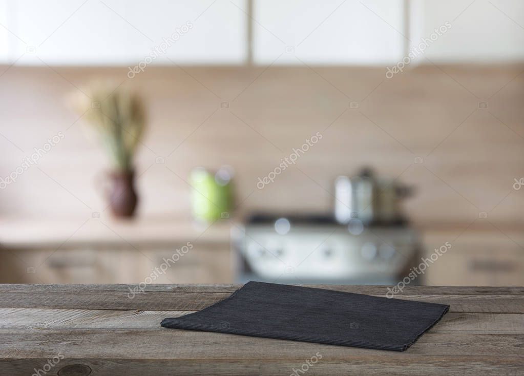 Blurred and abstract background. Empty wooden tabletop and defocused modern kitchen background for display or montage your products.