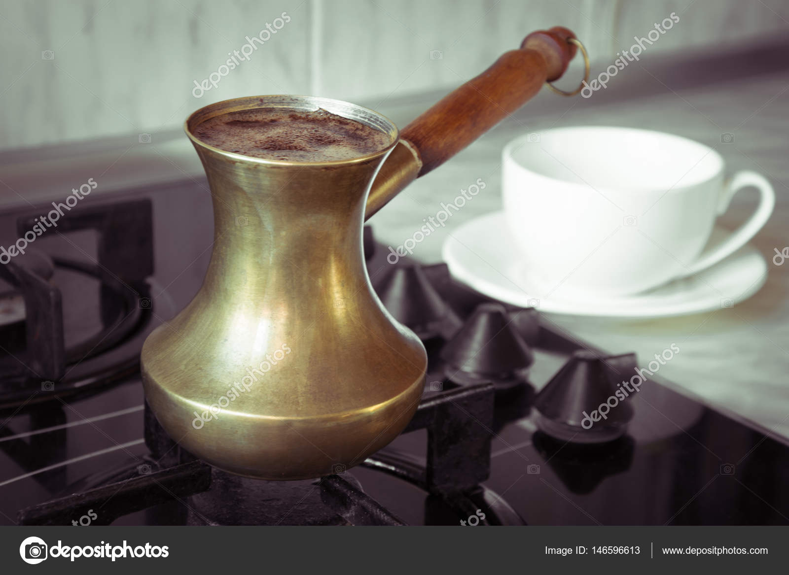 Old turkish copper pot for brewing coffee on stove. Early breakfast