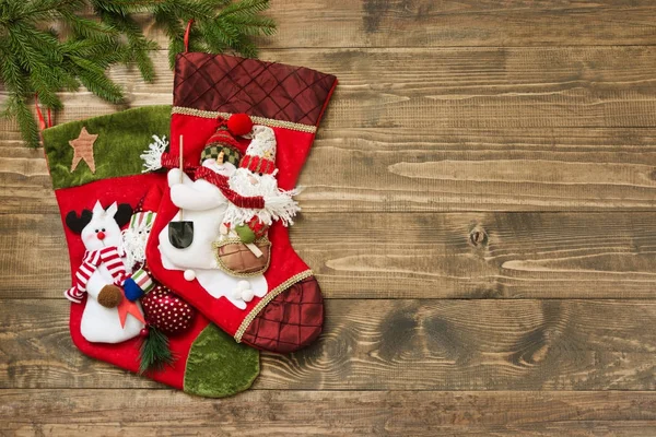 Abeto de Navidad, calcetines rojos de Navidad en el fondo de madera. Vista superior, espacio de copia — Foto de Stock
