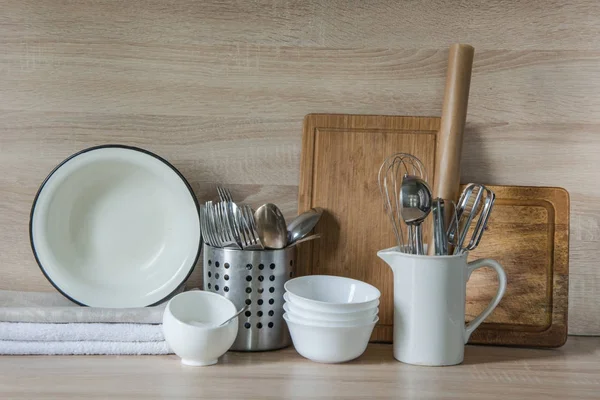 Crockery, tableware, utensils and other different stuff on wooden table-top.Kitchen still life as background for design.