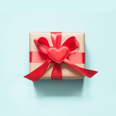 Sevgililer günü kartı. Kırmızı kurdele ve kalp mavi yüzeyi ile Hediyelik kullanır. Üstten Görünüm. Kare.