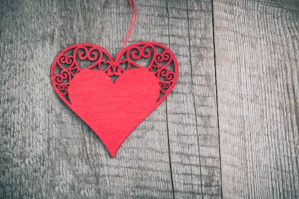 Открытка Валентина. Деревянное красное резное сердце на фоне деревянного стола с копировальным пространством . — стоковое фото