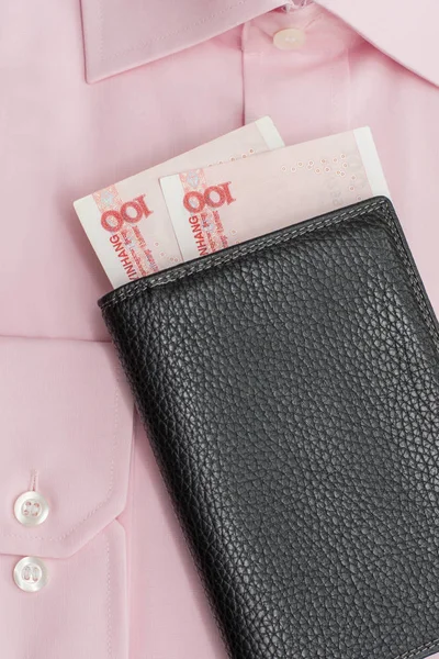 Pink shirt with two hundred chinese yuan in wallet.