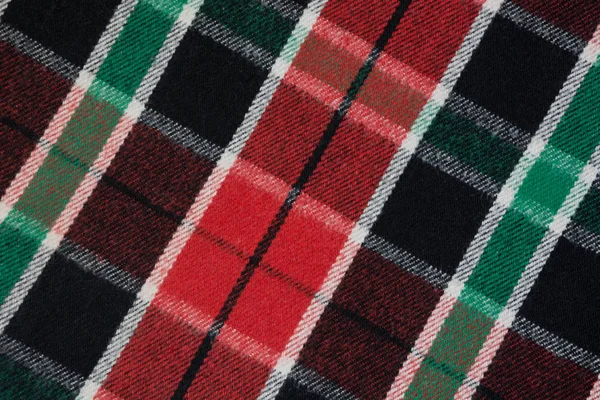 Manta macia de lã quadriculada. Textura verde e vermelha xadrez, macro shot. Padrão xadrez de lã. Superfície texturizada de pano quadriculado . — Fotografia de Stock
