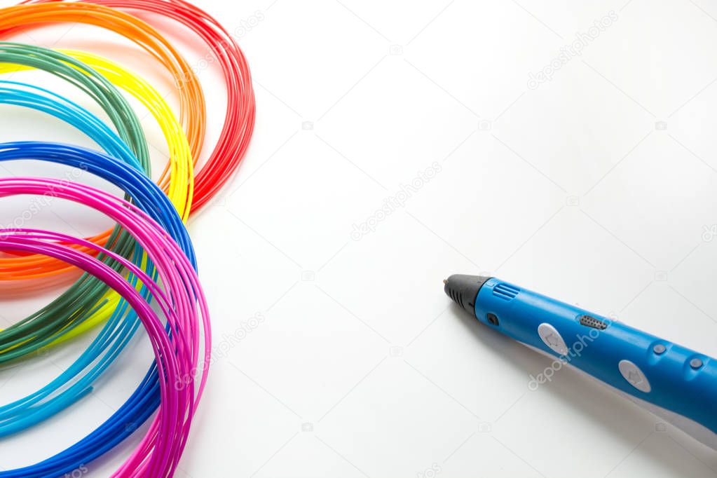 Colorful rainbow plastic filaments with 3D pen laying on white. New toy for child. 3d paintings and figures with their own hands.