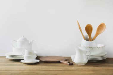 Beyaz mutfak gereçleri, dishware ve diğer farklı beyaz şey beyaz ahşap tahta üzerinde hizmet için.