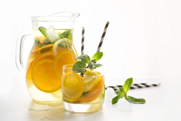 Summer fresh lemonade with citrus, orange and mint on yellow background. Copy space. — Stock Photo, Image