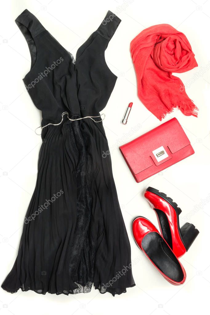 Elegant little women's black dress and red accessories for celebration or holiday. Flat lay.