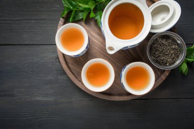 Çay seremonisi. Melissa 'yla bir fincan çay ve koyu tenli çaydanlık.